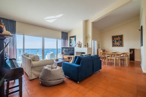 a living room with a blue couch and a table at Beach House - By WeHost in Santa Cruz