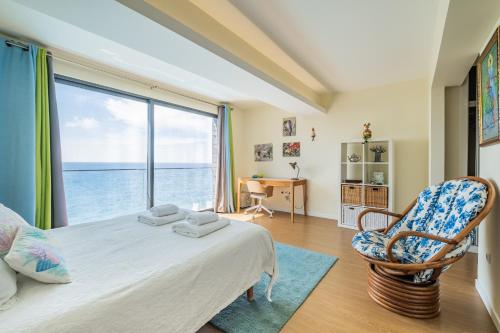 a bedroom with a bed and a large window at Beach House in Santa Cruz