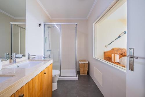 a bathroom with a shower and a sink and a toilet at Beach House - By WeHost in Santa Cruz