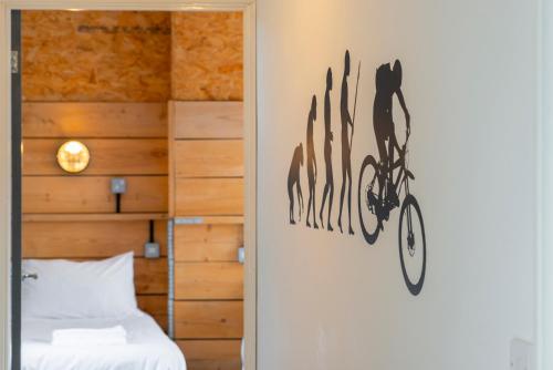 a bedroom with a cat on a bike wall art at Riverside by Afan Valley Escapes in Glyncorrwg