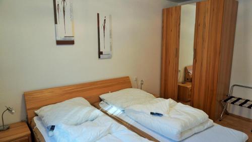 1 dormitorio con 2 camas con sábanas blancas en Lechbruck am See Feriendorf Hochbergle Haus 23, en Lechbruck