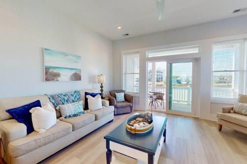 a living room with a couch and a table at Blue Oasis in Carolina Beach
