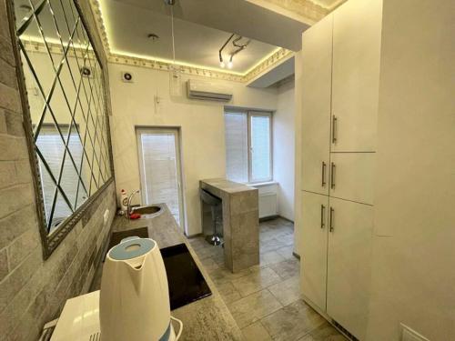 a bathroom with a sink and a desk in a room at Center Apartment in Chişinău