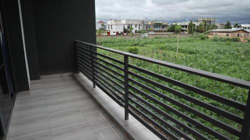 a balcony with a view of a field of crops at Maison Come and See Burundi Village A in Bujumbura