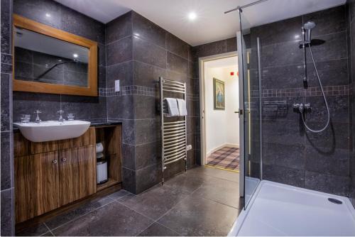 a bathroom with a sink and a shower at Yewfield Self Catering Apartments in Hawkshead