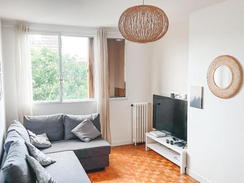 塞納河畔伊夫里的住宿－Suite familiale à Paris，带沙发和电视的客厅