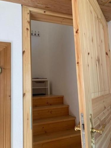 a stairway with a door to a room with a microwave at Große schöne Mansardenwohnung mit 2 Balkonen in Lofer