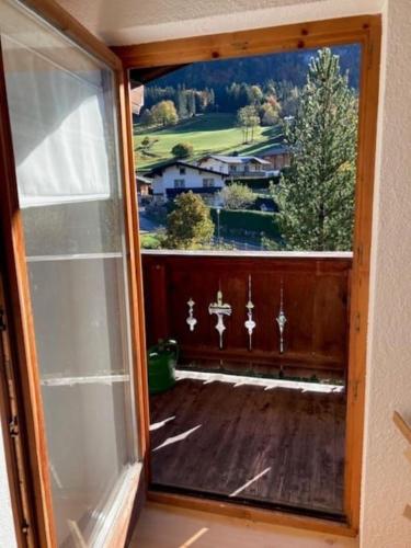 a room with a window with a view of a yard at Große schöne Mansardenwohnung mit 2 Balkonen in Lofer