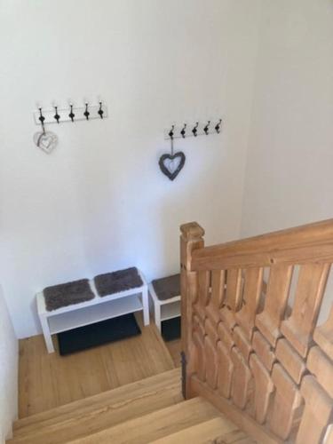 a bedroom with a bed and a table with a heart on the wall at Große schöne Mansardenwohnung mit 2 Balkonen in Lofer