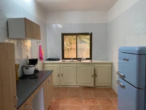 a kitchen with a sink and a refrigerator at Tropical House in Pamandzi