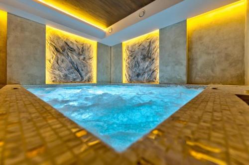 a pool of water in a room with rocks at Mans lux 8 Apartman in Zlatibor
