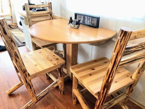 a wooden table and chairs in a room at Mountain View #615 in Whittier