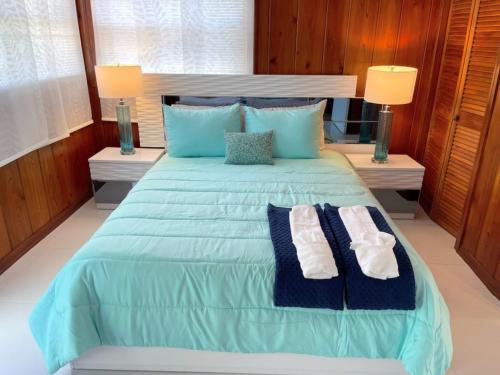 a large blue bed with two towels on it at Nature View #3 in Fort Myers Beach