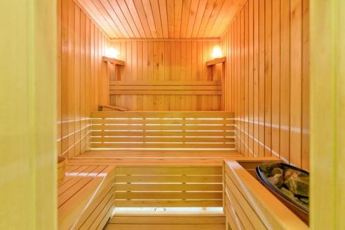 a sauna with wood paneling and a wooden floor at Mans lux 8 Apartman in Zlatibor