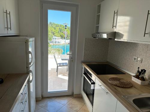a kitchen with a door leading to a patio at Villa Hosta Apartments in Hvar