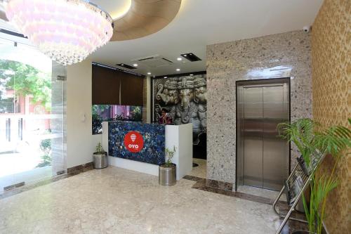 a lobby with a large chandelier in a building at Collection O Pearl Blue in Tājganj