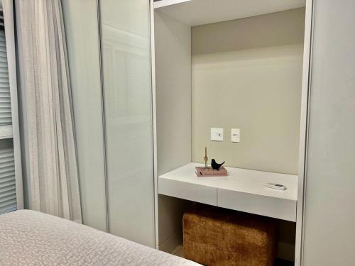 a bedroom with a mirror next to a bed at Vista MAR! Apto alto padrão in Governador Celso Ramos