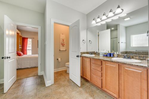 a bathroom with two sinks and a large mirror at Spacious Zachary Home 12 Mi to Baton Rouge! in Zachary