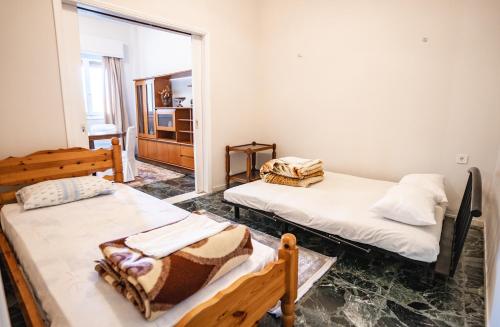 a room with two beds and a mirror at Apartment 105 sq.m. near center in Patra