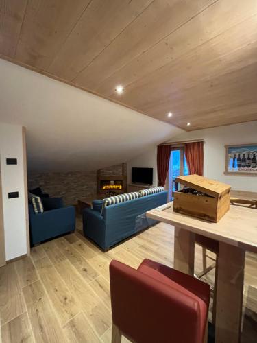 a living room with a blue couch and a table at Chalet Barbara in Livigno