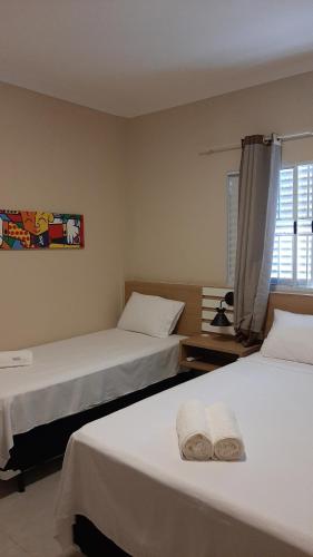 A bed or beds in a room at Farol das Aguas