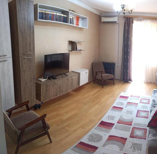 a living room with a flat screen tv and a couch at Apartment in Tskaltubo - # 1 in Tskaltubo