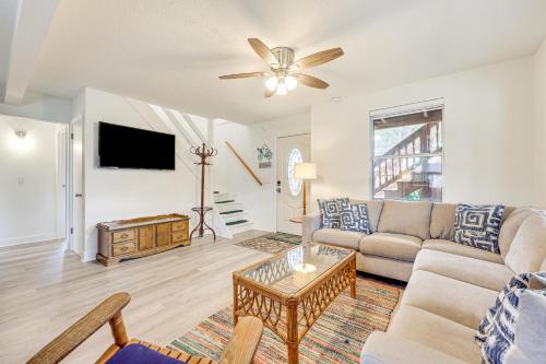 a living room with a couch and a tv at Canal-Front St Augustine Home with Dock and Pool! in Saint Augustine