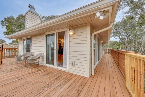 a house with a wooden deck with a chair on it at Canal-Front St Augustine Home with Dock and Pool! in Saint Augustine