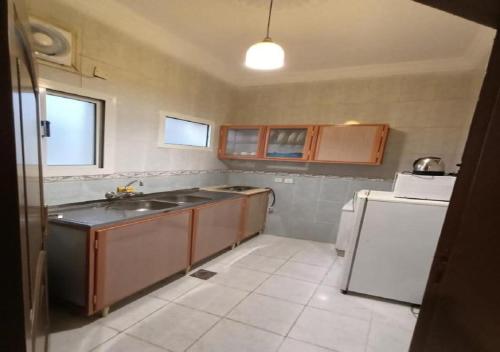 a kitchen with a sink and a refrigerator at فندق الافاق بالنسيم in Jeddah