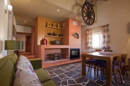 a living room with a couch and a table at Herdade da Urgueira in Vale de Pousadas