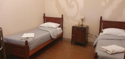 una habitación con 2 camas y una mesa con toallas en Nuestro Quincho en La Rioja