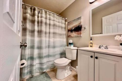 a bathroom with a toilet and a shower curtain at Remodeled 2 BDRM Ranch Attached Home Liberty, TWP in Rockdale