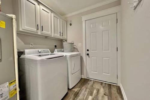 a white laundry room with a washer and dryer at Amazing riverside New Construction home in Middletown in Middletown