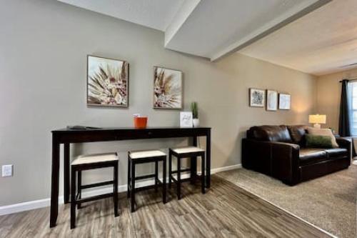 a living room with a table and chairs and a couch at Brand New Home Walking distance to Spooky Nook in Hamilton