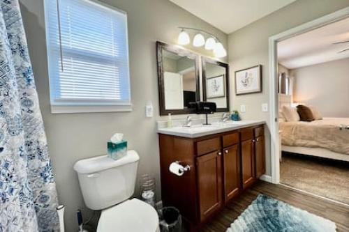 a bathroom with a toilet and a sink and a bed at Brand New Home Walking distance to Spooky Nook in Hamilton