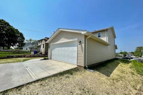 a small house with a garage and a driveway at Brand New Home Walking distance to Spooky Nook in Hamilton