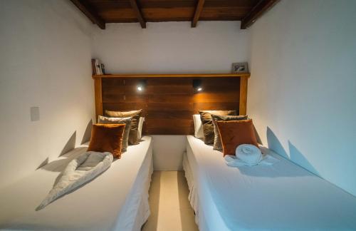a bedroom with two beds with pillows on them at ALTO MAR by Alto Atins in Atins