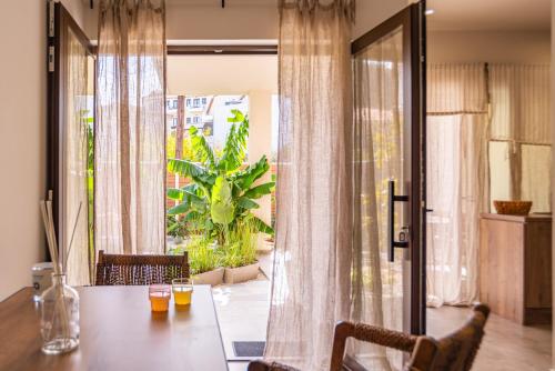 einen Esstisch mit Blick auf eine Terrasse in der Unterkunft Samos Tropic Apartments in Ríva