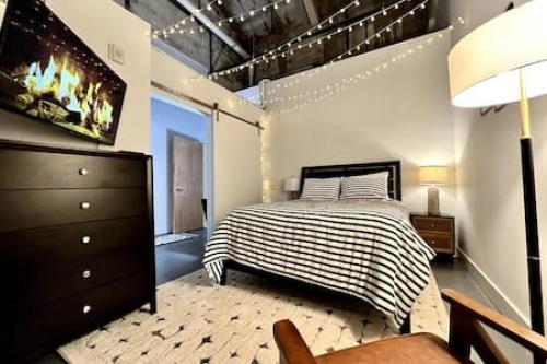 a bedroom with a bed and a dresser at 5104 Cartridge Factory Loft in Maineville