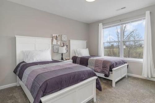 a bedroom with two beds and a window at BRAND NEW Home away from Home among the Nook in Hamilton