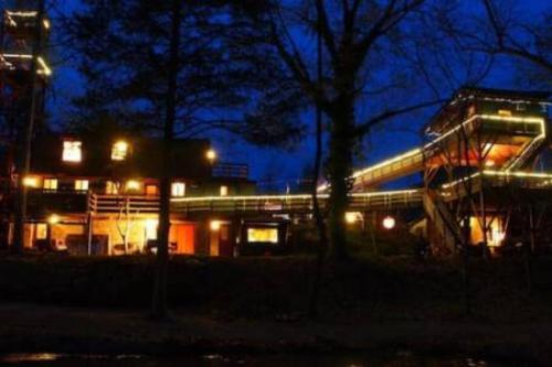 a building with lights in front of it at night at Treehouse at Castle in Stanardsville