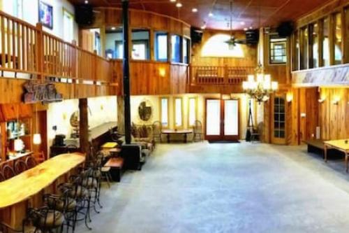 a large room with tables and chairs in a building at Treehouse at Castle in Stanardsville