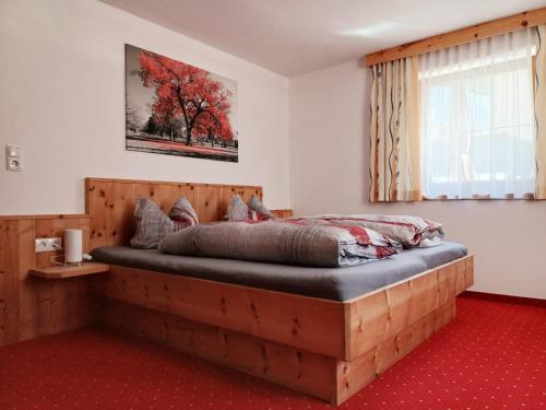 a bedroom with a bed made out of wood at Haus Gstrein in Oetz