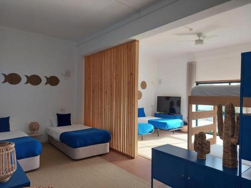 a bedroom with two beds and a television in it at Villa Nova Nautic & Nature in Eira do Chão