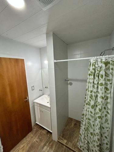 a bathroom with a shower curtain and a sink at Plaza Km 325 in San Lorenzo