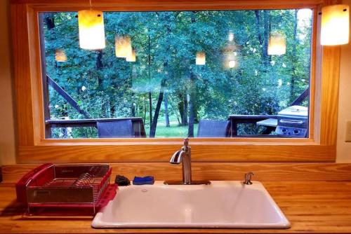 a kitchen sink in front of a window at Farmview Cottage at White Lotus Eco Spa Retreat in Stanardsville