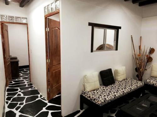 a room with a couch and a mirror on a wall at La cabaña del TIO PEPE in Taxco de Alarcón