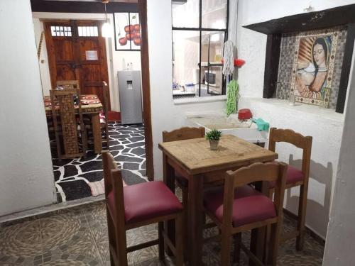 a dining room with a table and two chairs at La cabaña del TIO PEPE in Taxco de Alarcón