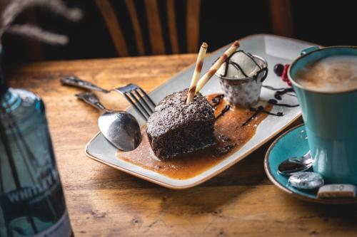un piatto di torta al cioccolato e una tazza di caffè di The Manor a St Bees