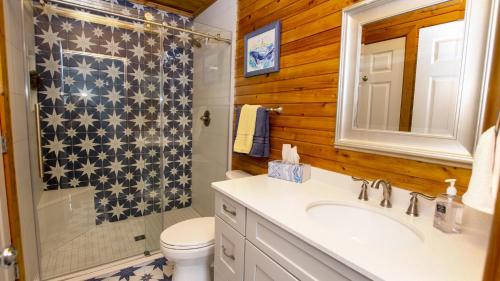 a bathroom with a toilet and a sink and a shower at Oceanside, Private Pool, Walking distance to town of Duck, Foosball, T3, Bella Vita in Duck